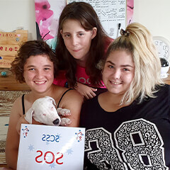 Three girls holding a SCSS NDIS appreciation certificate