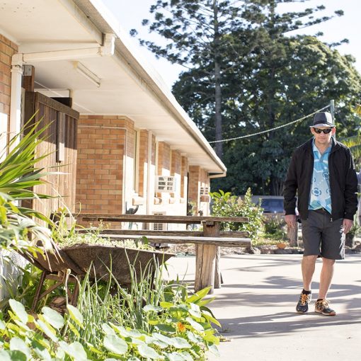 Two people walking outside short-term accommodation building