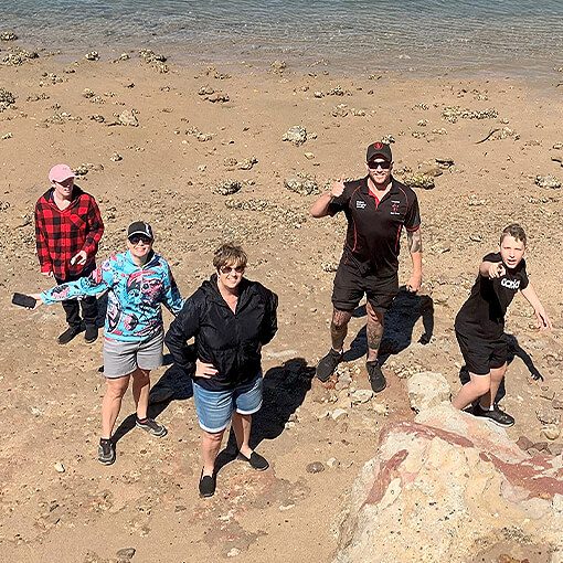 Group of people having fun at the beach with support worker