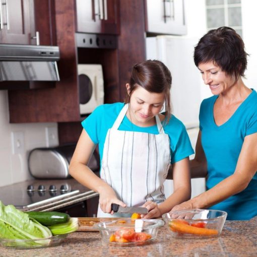 Young girl learning to cook via child protection support program