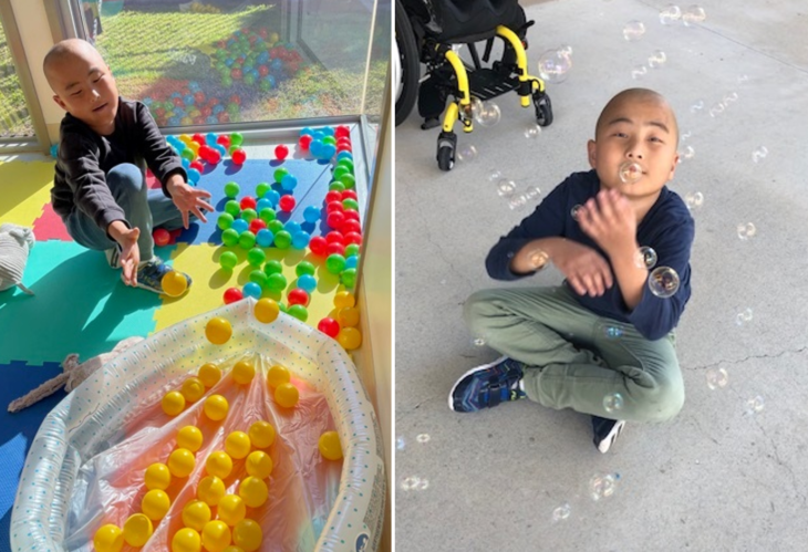 child sitting on ground blowing bubbles at Skoolz Out NDIS Holiday Care Program